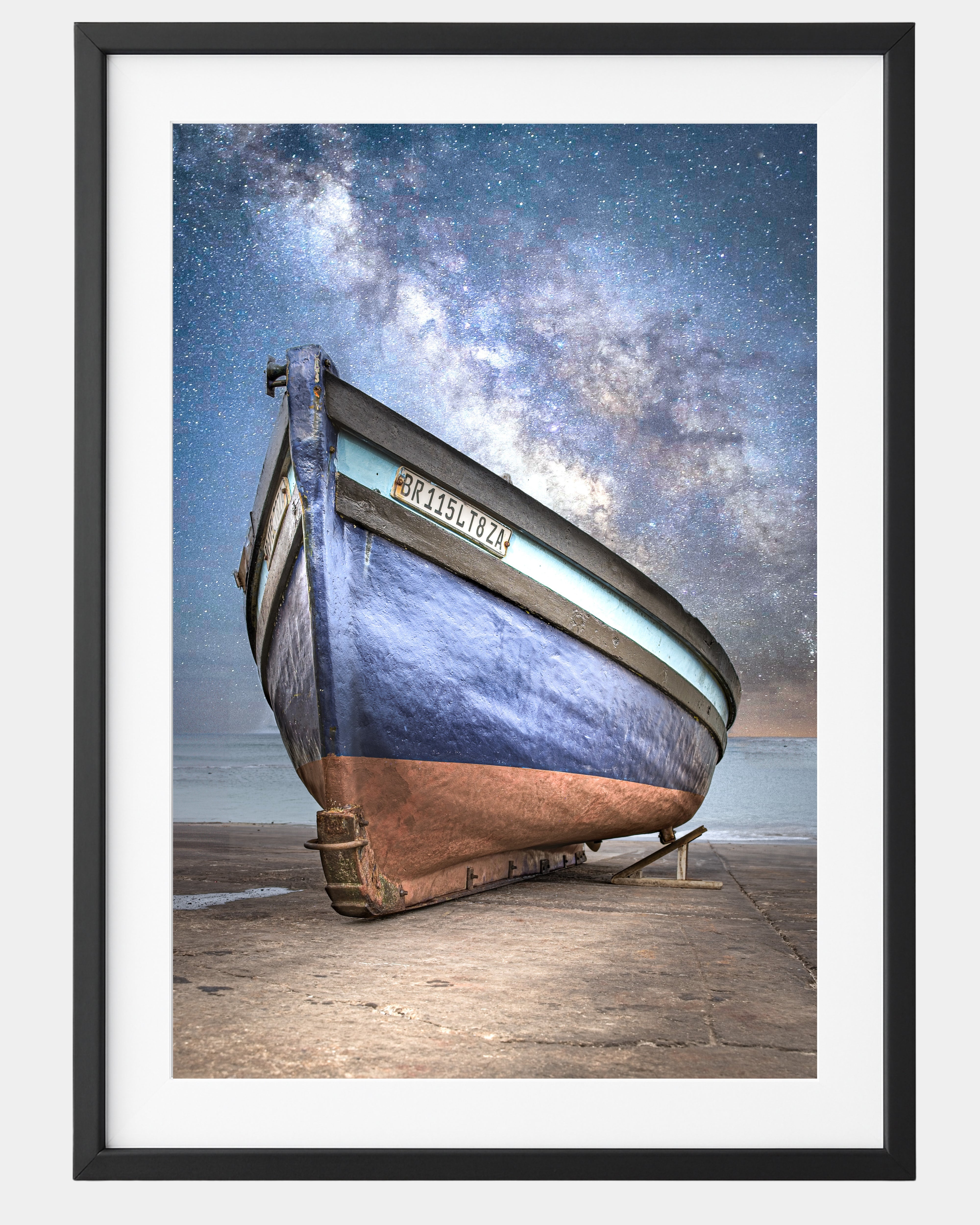 Framed artwork of a boat on a dock with a starry night sky.